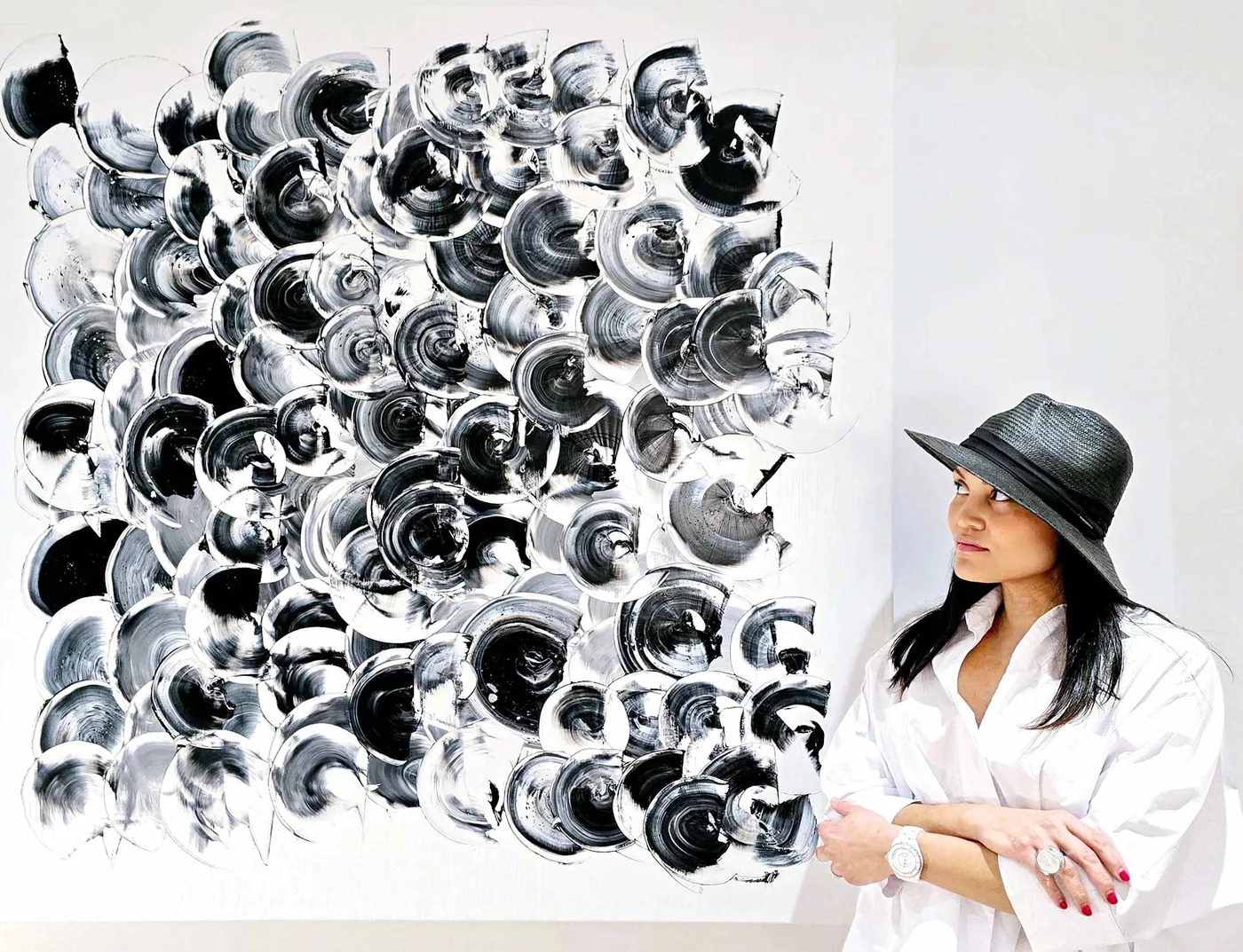 Juliana Haggoo beside a black and white canvas